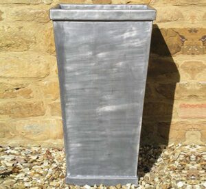 The traditionally tapered Burford lead planter by Oxford Planters.