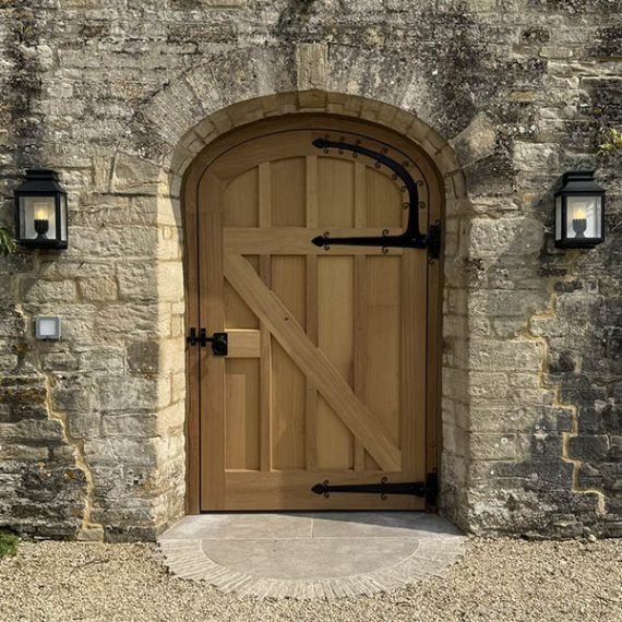 Bespoke replication of a luxury Arts and Crafts arched timber gate, handcrafted in a historic period style with traditional hardwood joinery.