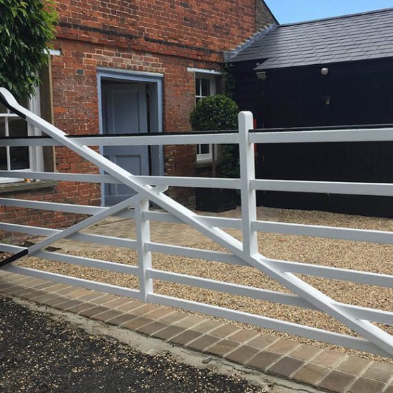 Bespoke architectural luxury timber courtyard driveway accoya gate, handcrafted in a farmhouse five-bar design with a painted finish.