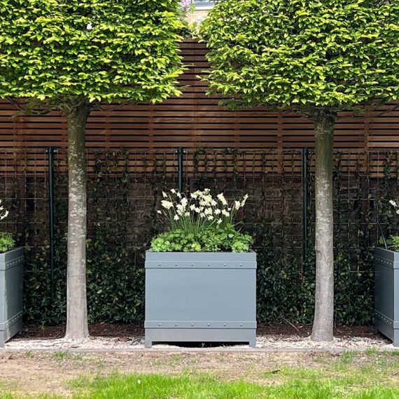 Accoya and spray coated wooden castle cube planters with studded detail brace.