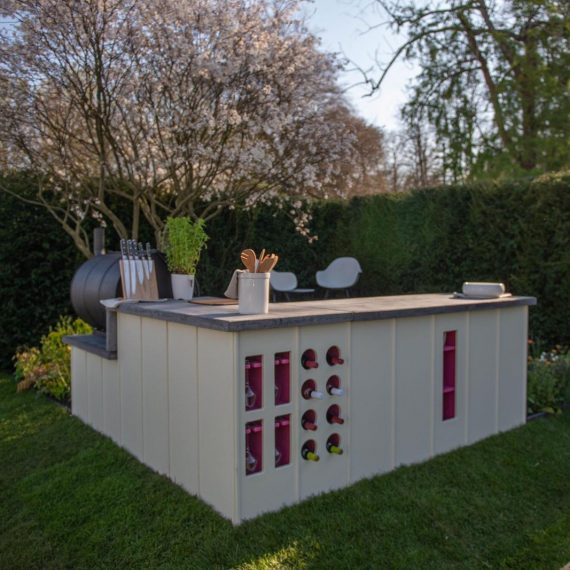 Fluted bespoke outdoor kitchen with wine storage.