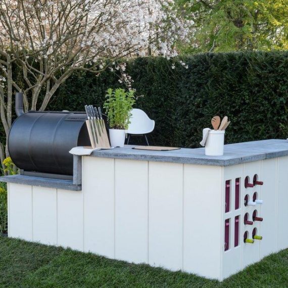 Bespoke outdoor kitchen in white with pink detail