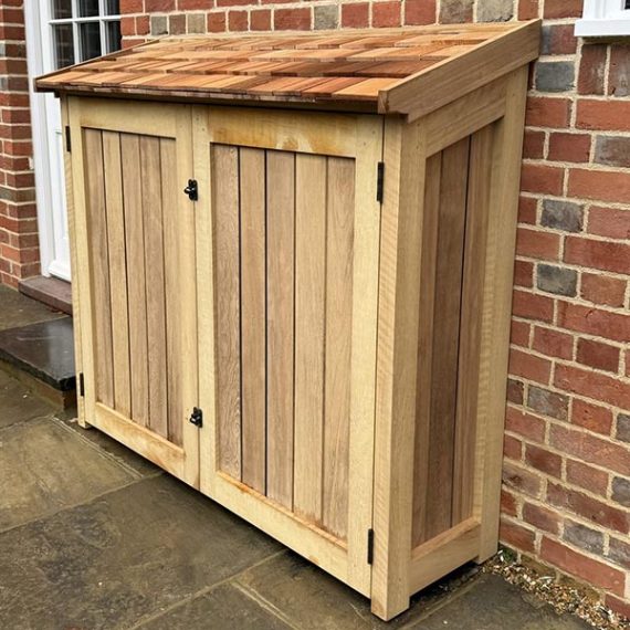 Luxury hardwood outdoor storage cupboard with cedar shingle roof.