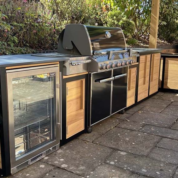 ArtDeco bespoke, handmade outdoor kitchen in oak with a herb planter and black metal frame.