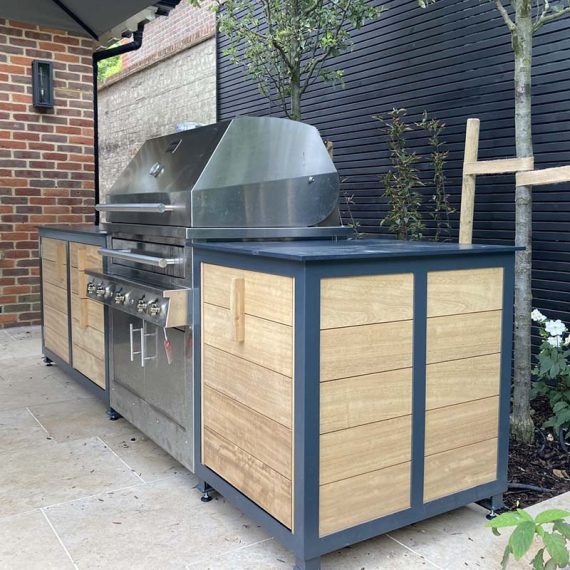 ArtDeco Hand-made Bespoke Wooden Outdoor Kitchen with BBQ in air-dried oak and blue metal frame.