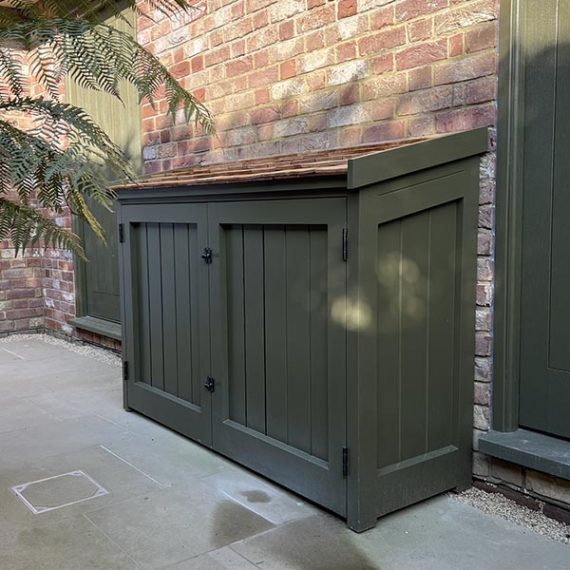 Painted olive green outdoor cupboard with cedar shingle roof, bespoke made to order in UK.