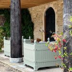 Versailles planters in green at a country estate.