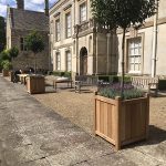 Hertford wooden planter displayed in formal garden setting
