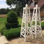 Pair of handcrafted white painted Accoya garden tuteurs with intermittent treillage.