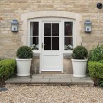 Bespoke barrel wooden planters with Buxus balls at a Cotswold property entrance