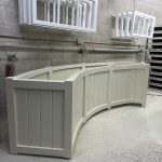 Bespoke curved Accoya wooden trough planter with traditional panelled detailing, handcrafted to follow a sweeping curve.