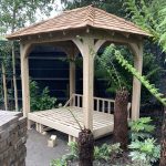 Bespoke Oak rocking daybed with cedar shingle roof in a Wimbledon garden