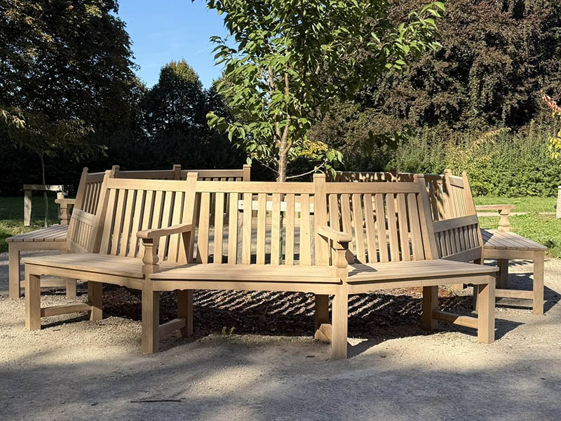 Dodecagon Accessible Oak Wooden Bench Bespoke twelve-sided oak circular tree seat bench handcrafted from solid oak, featuring built-in accessible open spaces for wheelchairs and pushchairs around a central lawn tree.
