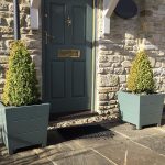 12-year-old tapered Accoya wooden planters at a property entrance