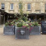 Traditional, bespoke cube lead planters with integrally embossed crest.