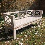 White Low Backrest Wooden Designer Stud Bench Bespoke painted low-back outdoor Accoya bench with lattice framing and copper stud accent.
