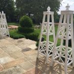 Handcrafted white Accoya garden tuteurs with staggered lattice joinery and teardrop finials, made in England.